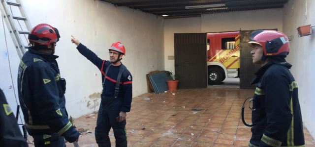 Els bombers asseguren la xapa metàl·lica d’una teulada per a evitar que el vent l’arranque